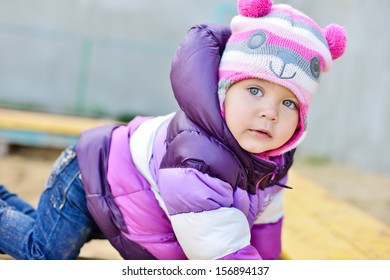 Toddler On The Playground In Cold Weather