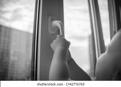 Toddler Opens The Window. Children Safety At Home. Prevention Of Falling Accident. Black And White Dramatic Portrait. Space For Text