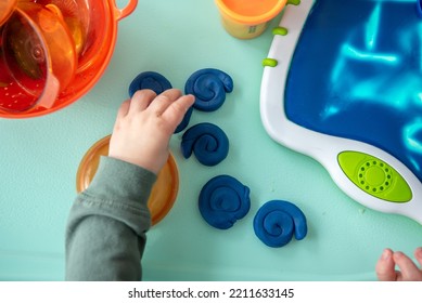 Toddler Playing With Blue Modeling Clay Or Play Dough