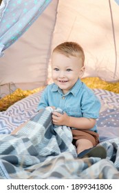 Toddler Playing In Cotton Teepee. One Year Cute Boy In A Teepee Outdoors.