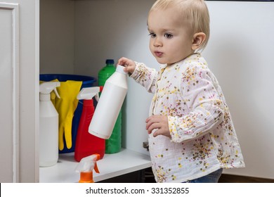 Toddler Playing With Household Cleaners At Home