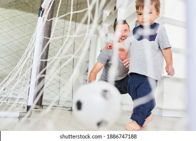 Toddler Playing Soccer Scores A Goal Together With Father In The Living Room