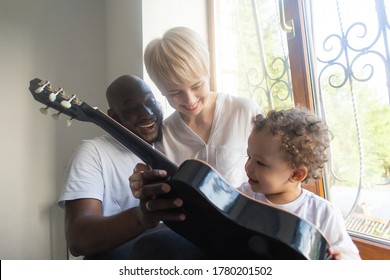 The Toddler Plays Guitar With Mom