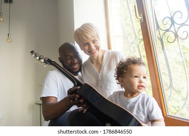 The Toddler Plays Guitar With Mom