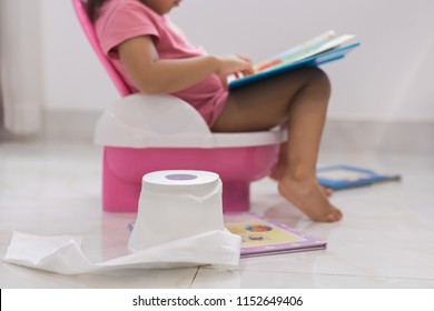 Toddler potty training. reading books on the toilet.