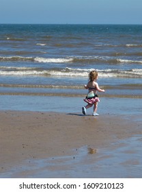 Toddler Running On Beach At Filey