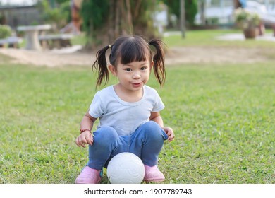 Portrait​ Image​ Of​ 2-3​ Years​ Old​ Of​ Baby​ Toddler. Happy​ Asian​ Child​ Girl​ Smiling, Running​ And Playing​ With​ A Ball Toy At The​ Green Garden Park​ Playground. Sport,  Exercise​ For​ Kid.