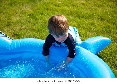 Toddler Splashing In Wading Pool