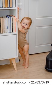 A Toddler Standing On His Tip Toes. Toe Walking. Developmental Milestones. A Baby Learning To Stand Up By Support.