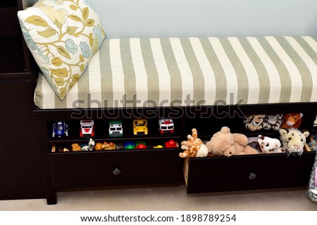 Toddler toy storage solutions in window bench in living room for easy clean up and tidy living