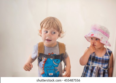 Toddlers Boy And Girl Pressed His Nose To The Glass.