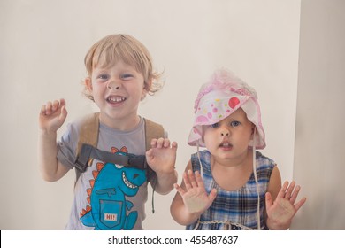 Toddlers Boy And Girl Pressed His Nose To The Glass.