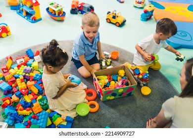 toddlers enjoying building blocks, cars, ships and other plastic toys in kindergarten. High quality photo - Powered by Shutterstock