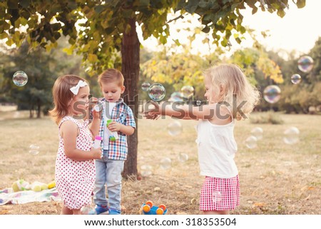 Similar – children playing in the sand, having a conversation over sand toys