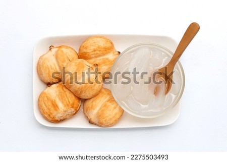 Toddy palm slices in syrup on white background.