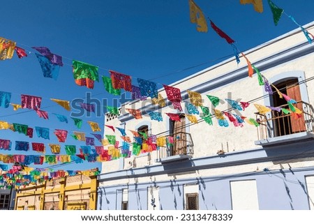 Todos santos, baja california sur, mexico. festive colorful banners over a street.
