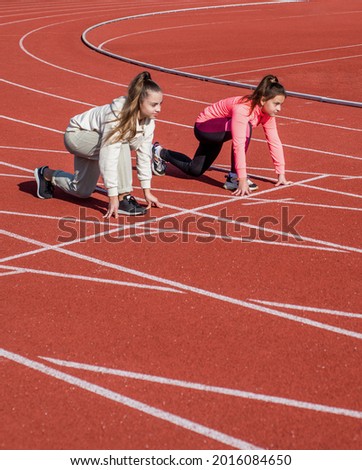 Toe the starting line. Athletic children in starting position. Running. Athletics. At the start