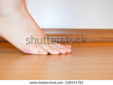 Toes on wood floor.