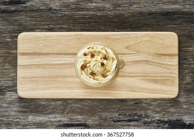 Toffee Nut Latte Cupcake On Wood Plate (Top View)