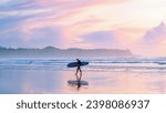 Tofino Beach Vancouver Island Pacific rim coast during sunset, surfers with surfboard during sunset at the beach, Canada Vancouver Island Tofino Long beach