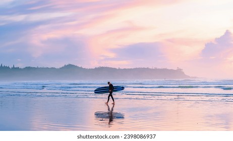 Tofino Beach Vancouver Island Pacific rim coast during sunset, surfers with surfboard during sunset at the beach, Canada Vancouver Island Tofino Long beach - Powered by Shutterstock