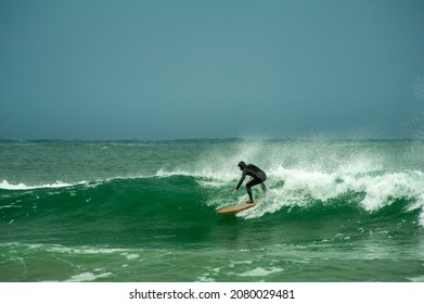 Tofino, British Columbia, Canada - November 05, 2021 - Surfer riding the ocean waves in Cox Bay