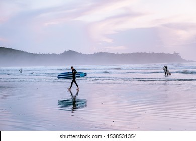 Tofino Vancouver Island Canada September 2019, surfers on the beach of Cox Bay during sunset , a popular surf spot at Tofino