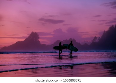 Tofino Vancouver Island, sunset at cox bay with surfers by the ocean during fall season Canada