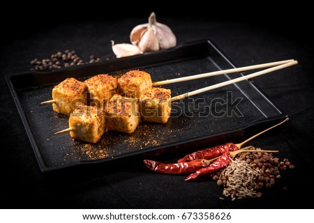 tofu mala grilled on table with blackground (selective focusing)