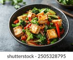 Tofu stir-fry with mixed vegetables arranged in a bowl, showcasing vibrant colors and textures, high-quality food photography from a top-down view.