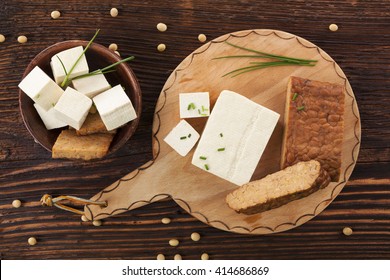 Tofu And Tempeh Background On Brown Wooden Background. Culinary Vegan Eating. 