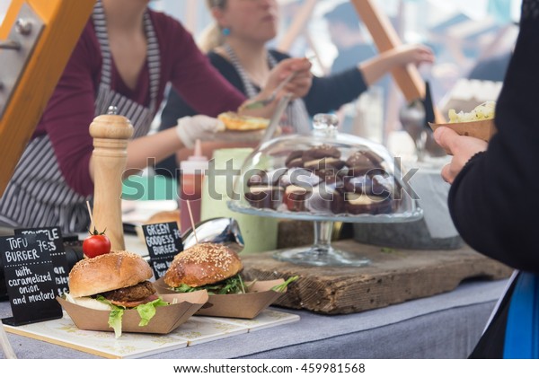 Tofu\
vegetarian burgers being served on food stall on open kitchen\
international food festival event of street\
food.