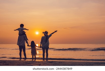 together, sun, sunset, sunrise, relaxation, parent, freedom, silhouette, son, beach. A family is standing on the beach, with the sun setting in the background. children are holding hands with parents. - Powered by Shutterstock