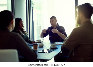 Together We Can Only Move Forward. Cropped Shot Of A Group Of Businesspeople Meeting In The Boardroom.