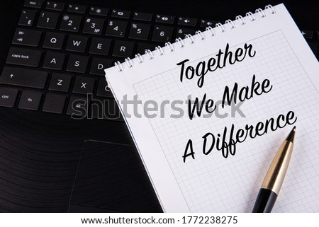 Together We Make A Difference, written on a notebook with a pen. 