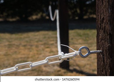 Toggle Bolt In Wooden Fence Post With Looping White Chain Links