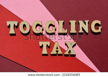 Toggling Tax, words in wooden alphabet letters isolated on red background. Buzzword refers to the equated cost per time spent to toggle between applications
