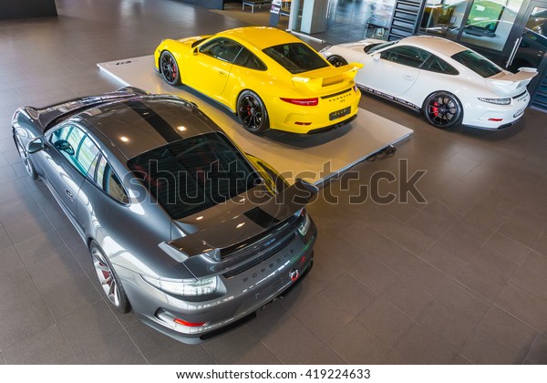 TOGLIATTI, RUSSIA - APRIL 11,\
2015: Porsche GT 3 in showroom Primjera as a Volkswagen dealer in\
SAMARA region of Russia. Six GT3 different color cars in one show\
room