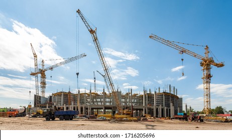Togliatti, Samara Oblast / Russia - August 04, 2011: Panorama of the construction site of the hockey arena with cranes, special mechanisms and various of construction equipment against sun and sky