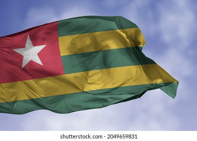 Togo flag isolated on the blue sky with clipping path. close up waving flag of Togo. flag symbols of Togolese.