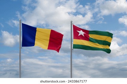 Togo, Togolese Republic and Romania flags waving together in the wind on blue cloudy sky, two country relationship concept