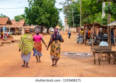 Togoville village in Togo. Women walking in African outfits in the village. Voodoo religion in Togo, West Africa. Togoville and Lomé voodoo markets.