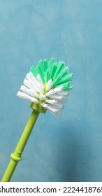 A toilet or bathroom brush on a blue background - Shutterstock ID 2224418765