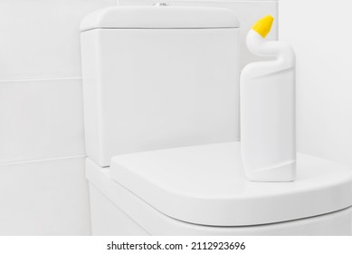 Toilet cleaner bottle mockup for design on white lavatory pan - Shutterstock ID 2112923696