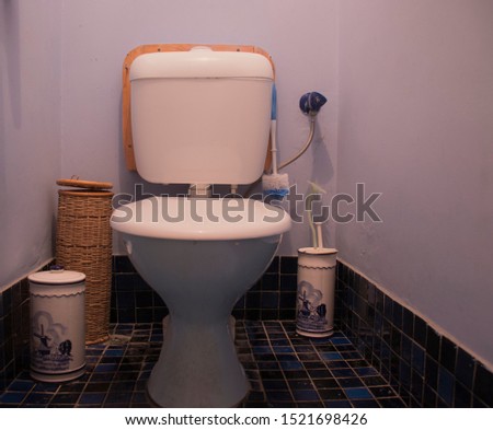 Toilet covered in dust surrounded by cleaning apparatus