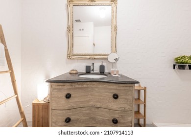 Toilet Decorated With Stripped Furniture And Matching Square Mirror With Black Marble Sink In Vacation Rental Apartment