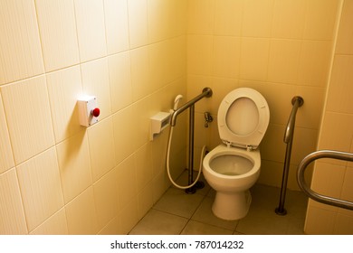 Toilet For Handicap Room With Red Electric Buzzer Background