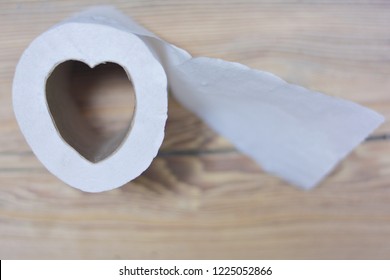 Toilet Paper In The Form Of Heart. Wooden Background.