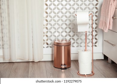 Toilet Paper Holder With Rolls And Trash Bin In Bathroom Interior