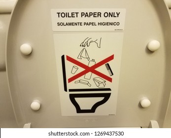 Toilet Paper Only Sign On Airplane Toilet Lid